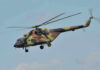 Army Helicopters Buzz Kid Rock Estate—Investigation Launched Camouflage military helicopter in flight against blue sky.
