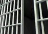 Close-up of prison cell bars.
