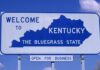 Welcome sign for Kentucky, the Bluegrass State, with a blue background