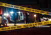 Yellow police tape in front of crime scene.