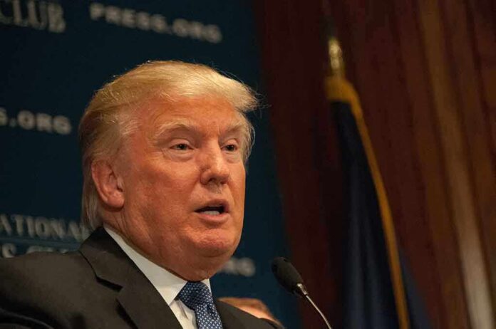 A public figure speaking at a podium during a press conference