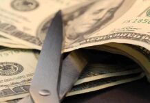 MASSIVE Nike Collapse — Lowest Since 2014! Scissors cutting through a stack of dollar bills