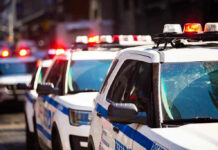Seattle Neighbors SHOCK City — Barricades Up! Police cars with flashing lights in line formation.