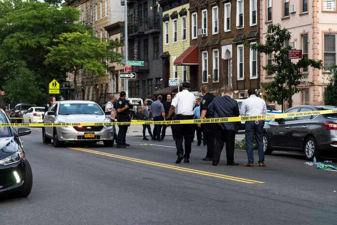 1437619223 Police gathered at an urban crime scene.