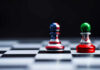 Chess pieces with USA and Iran flags on board.