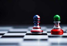 Chess pieces with USA and Iran flags on board.