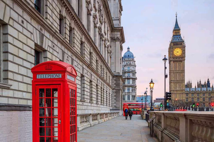 370728353 Red telephone booth near Big Ben in London.