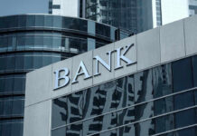 Bank building with glass facade and modern architecture.