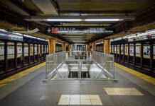 NY Governor vs. Trump: Rail Strike Blame War! Subway station platform with directional signs overhead.