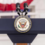 Vice Presidential podium with microphones and emblem.