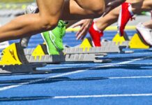 California’s Bold Move: Gender Rules Upended Athletes starting a sprint from starting blocks on a blue track