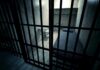 Pandemic Fraud Case Ends in Staggering 41-Year Sentence Interior view of a prison cell with a bed and metal bars