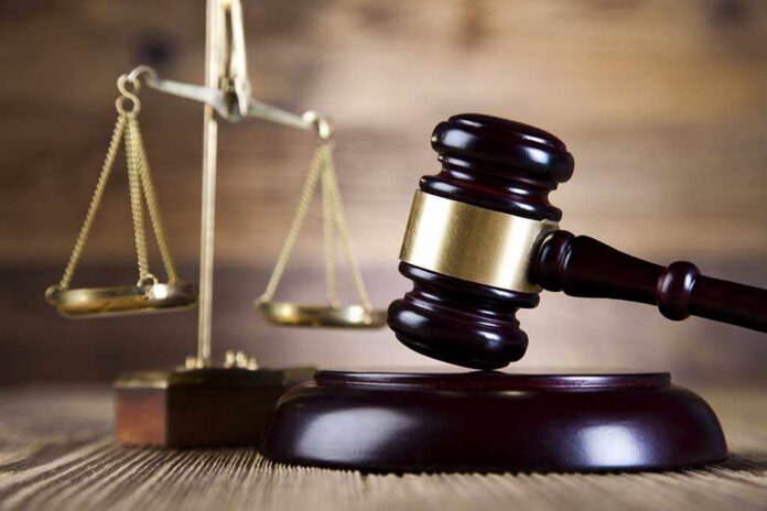 Justice,Scale,And,Gavel A wooden gavel and scales of justice on a wooden surface