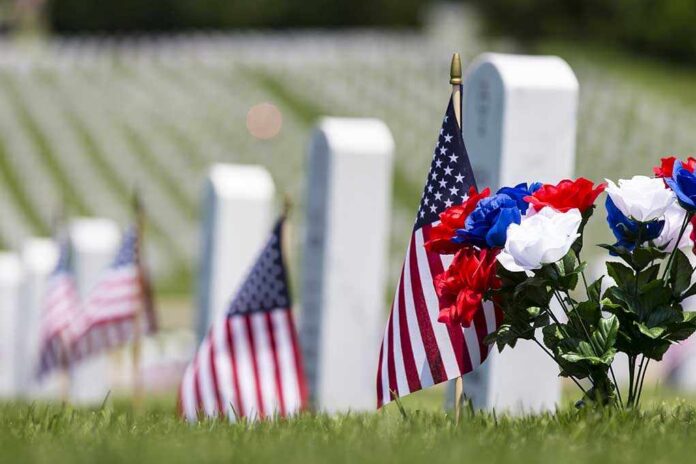 Veterans,Cemetery,Memorial,Celebration,With,American,Flag American flags and flowers placed at graves in a cemetery