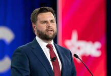 Rubio’s Explosive Surge Shakes GOP Field A man in a suit speaking at a podium during a conference