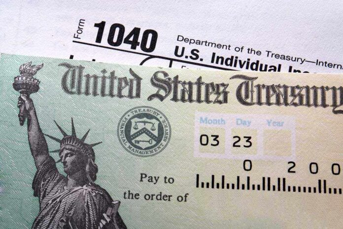 Tax,Return,Check,On,1040,Form,Background Close-up of a U.S. Treasury check and tax form 1040