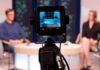 Trump Assassination Attempt Sparks Media Blame War Camera focused on a television studio interview with two seated hosts