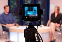Trump Assassination Attempt Sparks Media Blame War Camera focused on a television studio interview with two seated hosts