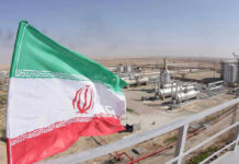 Iran ‘Dismantles’ Nukes? Watch The Fine Print Iranian flag near an industrial gas refinery.
