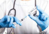 Ozempic Twist: Cancer Risk Plunges? Doctor filling syringe with vaccine from vial.