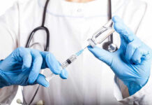 Ozempic Twist: Cancer Risk Plunges? Doctor filling syringe with vaccine from vial.