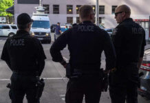 Active Shooter Terror Grips Midland Three police officers standing on a city street.