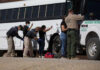 Trump’s Border Flip Shocks Cartels Border patrol officers investigating people near a bus.