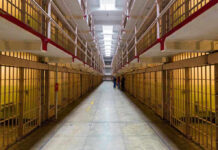 Early Release Bombshell Rocks North Carolina Long hallway with prison cells on both sides.