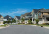 Horrifying 2000 Murder, Name Finally Revealed Suburban street with colorful, modern houses.