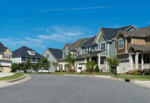 Horrifying 2000 Murder, Name Finally Revealed Suburban street with colorful, modern houses.