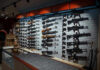 Background Checks Surge — What’s Coming July 1? Wall-mounted guns displayed in a store.