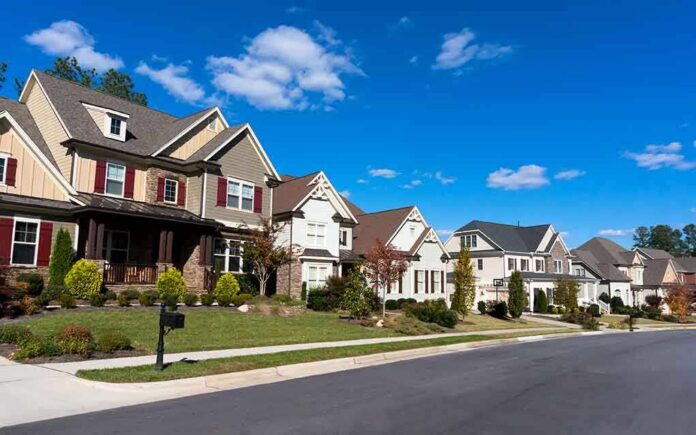 shutterstock_161232668-1 A row of modern suburban houses under a clear blue sky
