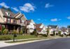 Housing Dream Becomes Locked Door A row of modern suburban houses under a clear blue sky