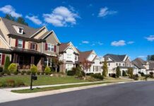 Housing Dream Becomes Locked Door A row of modern suburban houses under a clear blue sky
