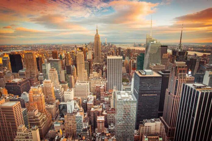 Aerial view of New York City skyline during sunset with skyscrapers and clouds