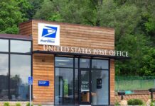 Exterior view of a modern United States Post Office building surrounded by greenery