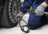 Auto Giants Plot Lockdown — Trump Strikes Back Mechanic inflating a car tire in a workshop