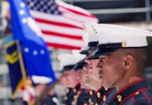 Leaked Tape Shocks Quantico U.S. Marines in uniform standing in formation with flags in the background