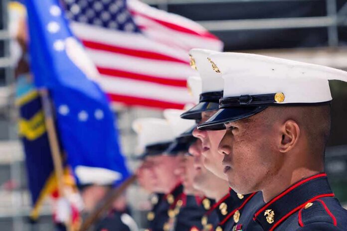 shutterstock_355868381 U.S. Marines in uniform standing in formation with flags in the background
