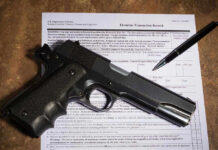 Supreme Silence Ignites Gun-Rights Chaos Gun and pen on firearm transaction form.