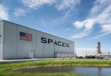 Last-Second Abort Stuns SpaceX SpaceX building with American flag and launch pad.