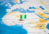 Flag pin marking Nigeria on Africa map.