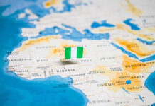 56 Days Vanish—Classroom Abductees Back Flag pin marking Nigeria on Africa map.