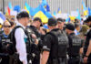 Stunning Lapses Put Trump In The Crosshairs Police officers gathered near a crowd with flags.