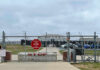 Mass Removal Flights Get New Launchpad Chain-link fence with Restricted Area Stop No Photography sign.