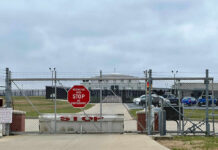 Mass Removal Flights Get New Launchpad Chain-link fence with Restricted Area Stop No Photography sign.
