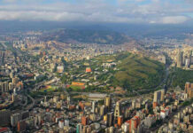 Tourists Leave Shocked: America… Works? Aerial view of a city with hills and buildings.