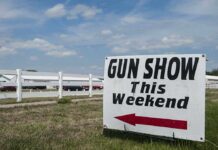 July 4 Hijacked: Rights Under Fire Sign advertising a gun show happening this weekend with an arrow pointing left