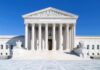 War Leaks Drag Media Into Crosshairs The Supreme Court building featuring marble columns and a clear blue sky