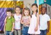 Locker Room Rules Ignite YMCA Firestorm Five children standing together in a playground setting, smiling at the camera